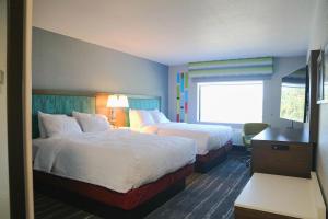 a hotel room with two beds and a window at Hampton Inn Lead in Lead