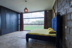 A bed or beds in a room at Amboseli Glass house