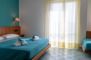 Postel nebo postele na pokoji v ubytování Hotel Alisei