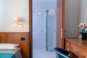 Postel nebo postele na pokoji v ubytování Hotel Alisei