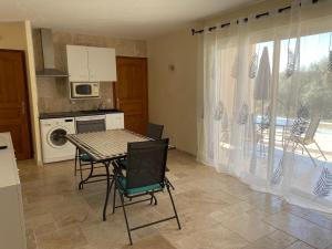 a kitchen with a table and chairs and a kitchen with a patio at Villa l'Olivier in Cagnes-sur-Mer