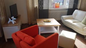 ein Wohnzimmer mit einer Couch und einem Tisch in der Unterkunft Ferienwohnungen Brasse in Dornumersiel