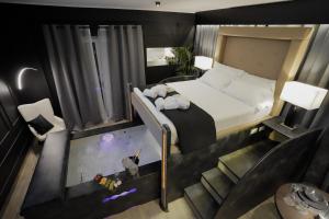a bedroom with a bed and a room with a staircase at Tomà Suites - Il Nido d’Amore in Rome