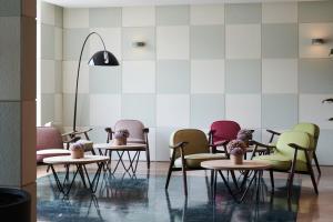 a row of tables and chairs in a waiting room at Catalonia Sabadell in Sabadell