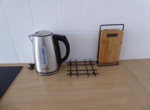 a coffee pot and a knife on a kitchen counter at Wohhhlfühl Appartement im Zentrum Graz in Graz