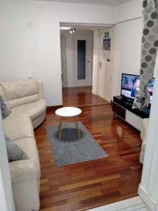 a living room with a white couch and a table at APARTAMENTO DANAE centro in Zumaia