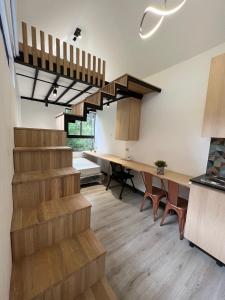 a living room with stairs and a dining room at Mini Casa en Poblado Medellín FRN109 By Roots Rentals in Medellín