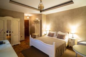 a bedroom with a white bed in a room at Hotel Europa in Târgu Jiu