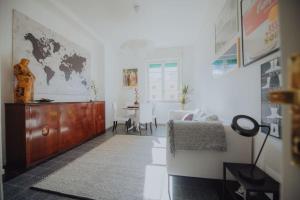 a white room with a bedroom with a desk and a bed at A casa di Giulia in Latina
