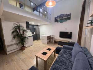 a living room with a couch and a table and a tv at Dublex Apartment in Yerevan komitas D1 in Yerevan