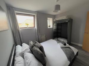 a bedroom with a white bed and a window at Princes Court, Sea Road in Bournemouth