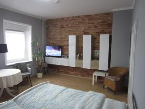 a bedroom with a bed and a brick wall at Michas FEWO 1 nähe Zentrum in Cottbus