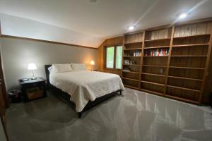 a bedroom with a bed and bookshelves and a bed sidx sidx sidx sidx at Turret House at Birchwood in Harbor Springs