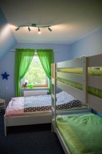 a bedroom with two bunk beds and a window at Dom Sielski w Górach Stołowych in Radków