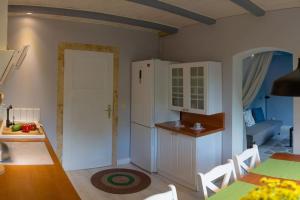 a kitchen and dining room with a table and chairs at Dom Sielski w Górach Stołowych in Radków +44 photos