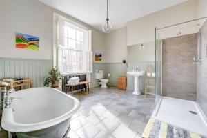 a bathroom with a bath tub and a sink at Host & Stay - The Georgian Townhouse in Liverpool