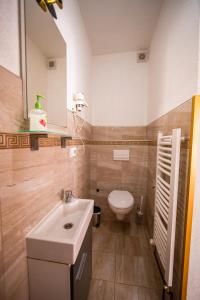 a bathroom with a white sink and a toilet at Apartmani Li in Livno +16 photos