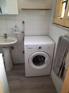 a washing machine in a bathroom with a sink at CASEVACANZASOTTOLETNA in Giarre