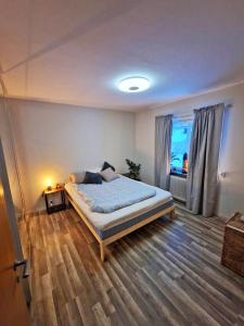 a bedroom with a large bed and a window at The High Coast House in Örnsköldsvik