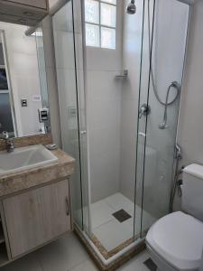 een badkamer met een douche, een wastafel en een toilet bij Novo, Lindo e pertinho do Shopping in Porto Alegre