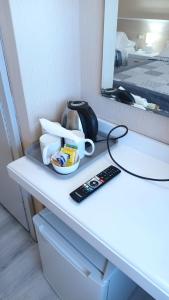a desk with a remote control and a mirror at Hotel Al Sant'Andrea in Sarzana