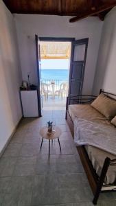 a bedroom with a bed and a table with a view of the ocean at Almia in Khalíkia