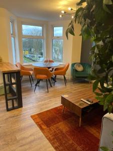 a living room with a table and chairs at The Lounge in Newquay +14 photos
