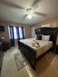 a bedroom with a bed with a ceiling fan at #2BR Cozy Villa - Mins to Historic STM Amusement Park! in Stone Mountain