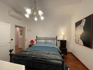 een slaapkamer met een bed en een schilderij aan de muur bij Appartamento Ristoro67 in Arezzo