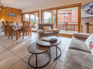 a living room with a couch and a table at Appartement Huez, 2 pièces, 5 personnes - FR-1-645-17 in LʼHuez