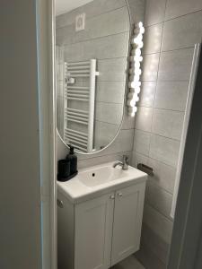 a bathroom with a sink and a mirror at La Petite Maison in Pont-d'Ouilly +9 photos