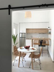 a kitchen and dining room with a table and chairs at Maria's Apartment in Knossós