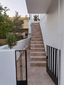 a staircase leading up to a building with a potted plant at Maria's Apartment in Knossós