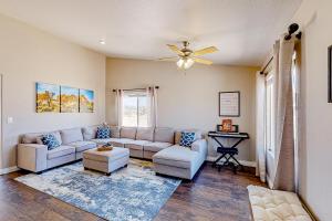 a living room with a couch and a ceiling fan at Mojave House in Joshua Tree