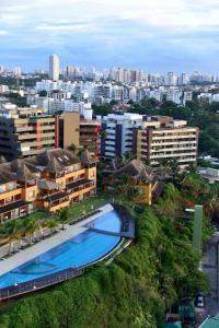 an aerial view of a city with a swimming pool at Ap climatizado com vista mar no Rio Vermelho in Salvador