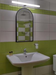 a bathroom with a white sink and a mirror at Guesthouse Lithos in Kalabaka