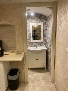 a bathroom with a sink and a mirror at Ciro House in Naples