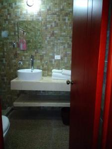 a bathroom with a sink and a toilet at LOS ARCOS in Agua Buena