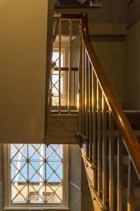 a stairway with a window and a stair case at Top Joe's Townhouse in Narberth