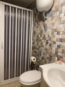 a bathroom with a toilet and a sink at Ciro House in Naples