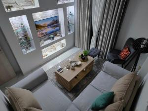 an overhead view of a living room with a couch and a table at Cozy Sea View Apartment in Paralia in Paralia Katerinis