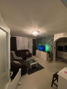 a living room with a couch and a tv at Apartman Kali in Banja Luka