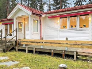 a small house with a wooden porch next to it at 6 person holiday home in PRÄSSEBO-By Traum in Eckerud