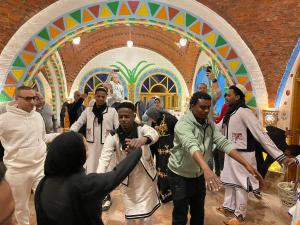 a group of people dancing in a room at Kato Dool Wellness Resort in Aswan