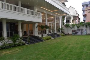 a building with a lawn in front of it at The White Lotus in Gaya