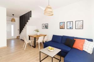 a living room with a blue couch and a table at Bura house in Pag