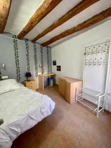 a bedroom with a bed and a desk in it at Alojamiento rural La Casona in Andorra