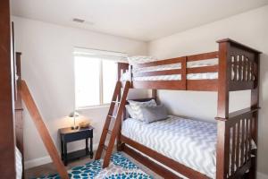 a bedroom with two bunk beds and a window at Coral Ridge Oasis 30 Mins From Zion NP 2 Pools in Washington +27 photos