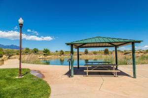 a picnic shelter with a picnic table next to a lake at Coral Ridge Oasis 30 Mins From Zion NP 2 Pools in Washington