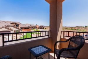Un balcón con 2 sillas y vistas. en Desert Lily I Spacious End Unit I Clubhouse I Golfing I Kid Friendly, en Washington